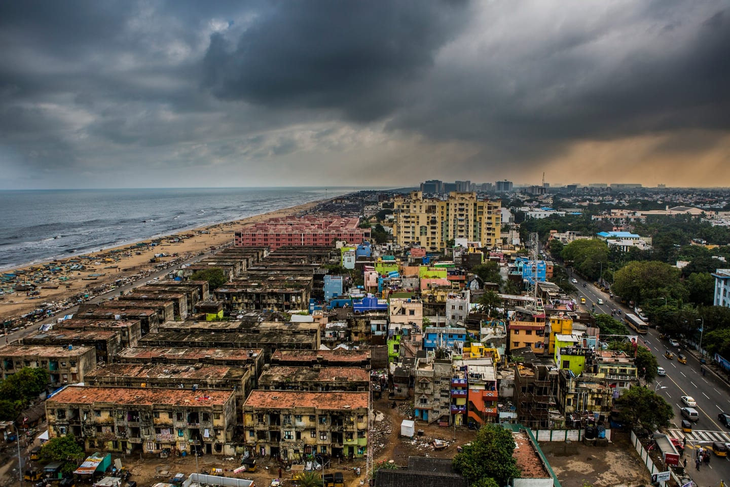 Aerial view of Chennai's shoreline and rooftops under dark monsoon cloud (Photo: Sriram Jagannathan, CC BY 2.0)